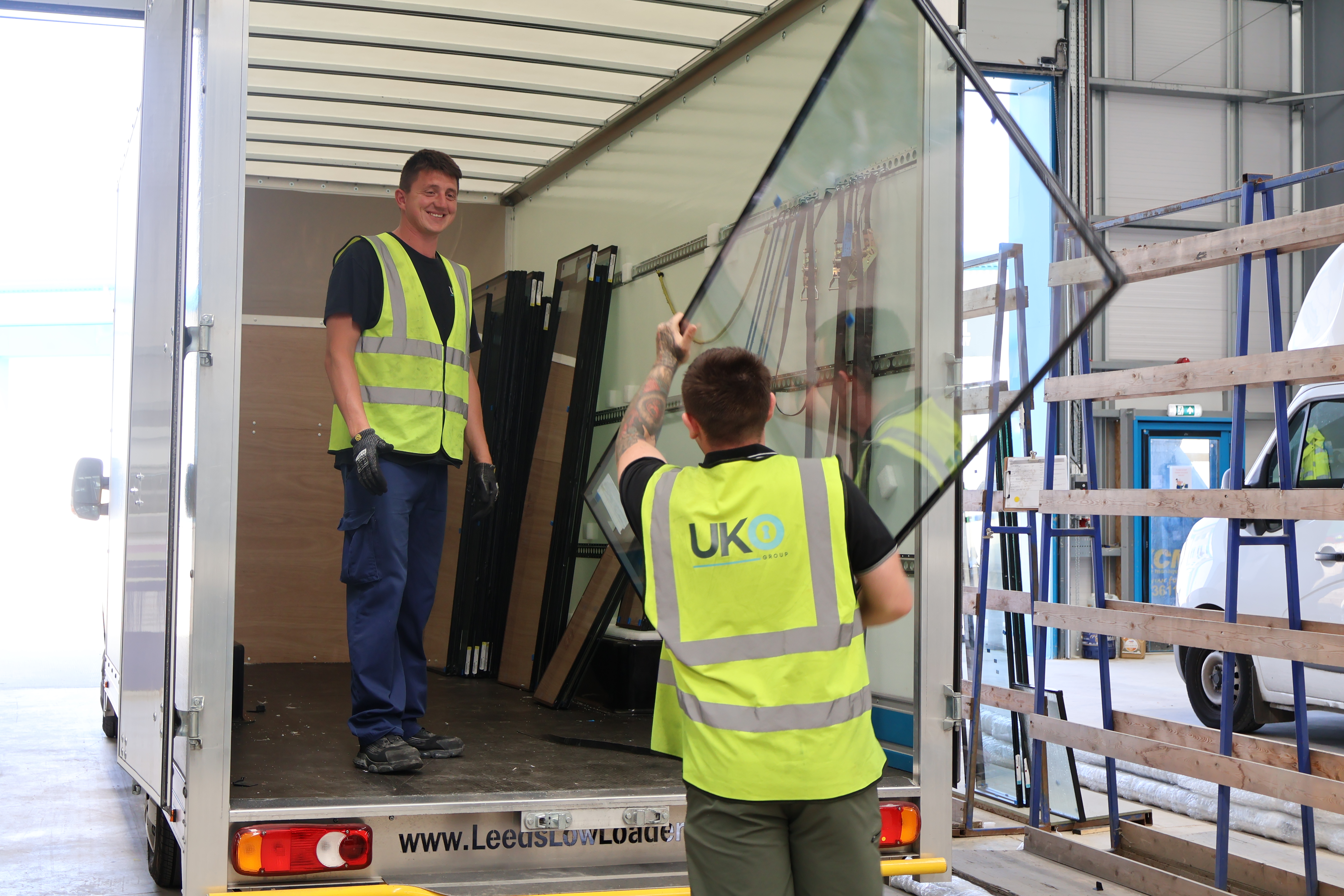 men loading glass onto van