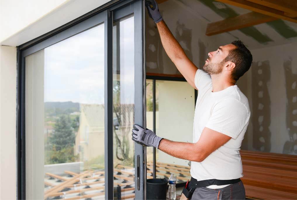 man installing bifold door