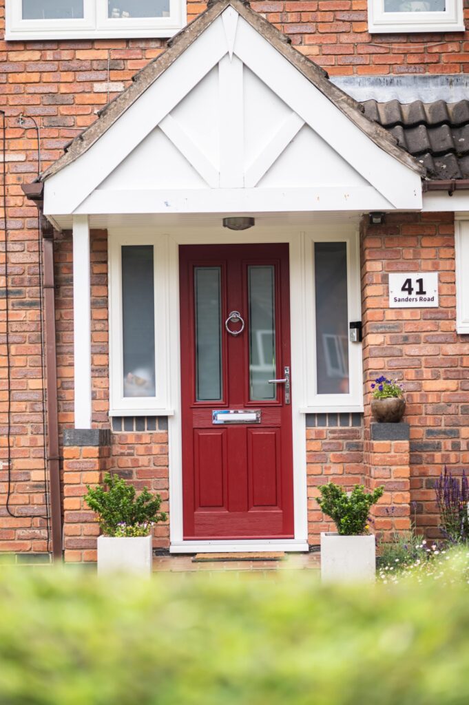 red door with small porch area
